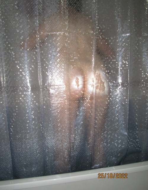 Steamy Shower Scene: Naked Woman Bathing in Bathroom