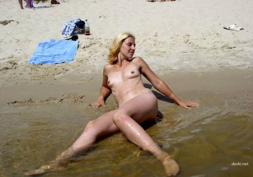 Explicit Nude Nudist Beach Photo: Naked Woman Sunbathing