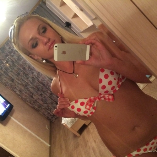 Blonde girl modestly takes nude selfies