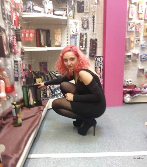 Uninhibited Seller of Intimate Goods Poses in Store - Explicit Adult Content