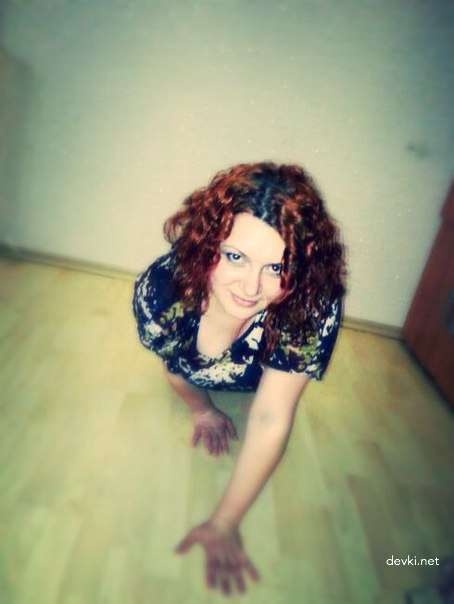 Fiery Seductress: Busty Redhead in Naughty Pose