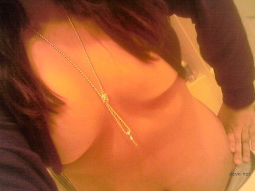 Topless Mulatto Beauty Exposing Her Breasts in Provocative Pose