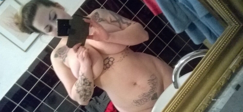 Voluptuous BBW with Tattoo Shows Off Curves in Stunning Photo