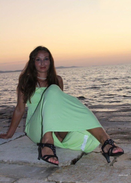 Explicit Intimate Photo of Woman in Fishnet Stockings