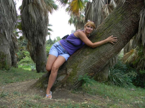Topless woman with huge breasts poses naked