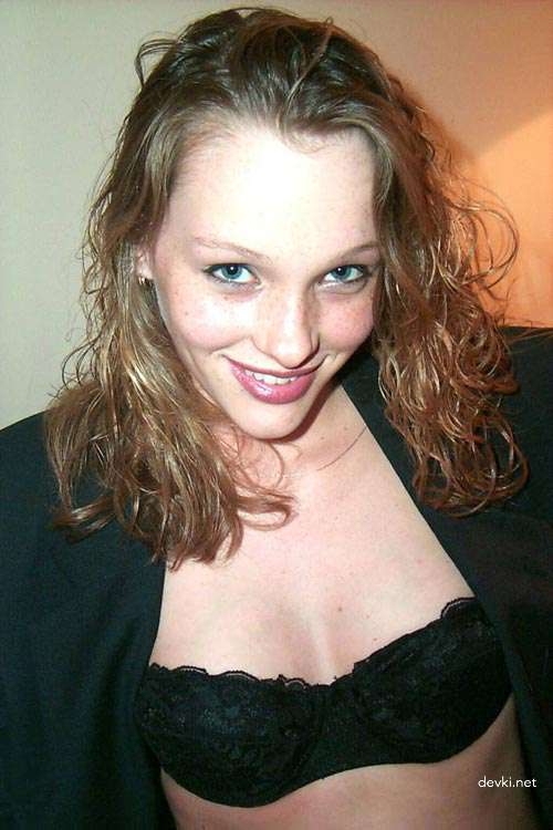 Sensual Curly-Haired Beauty in Erotic Pose: Seductive and Alluring Display of Sexuality