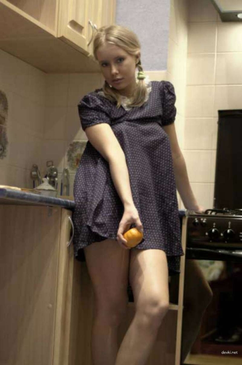 Kitchen Strip Tease: Hot Babe Lifts Dress for a Seductive Show