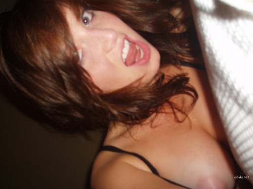 Topless babe posing seductively for erotic photoshoot