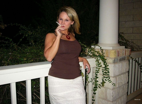 Mature Woman Smoking Cigarette: Bold and Explicit Photo