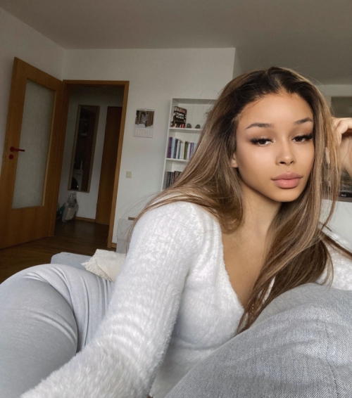 Young mulatto girl flaunts her tight pussy for the camera