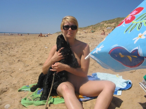 Naked Woman Sunbathing on Beach: Explicit Nude Beach Photo