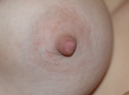 Super Busty Blonde Seductively Flaunts Her Assets in Revealing Top