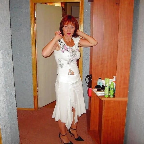 Redhead Woman Strips for Sex: Explicit and Sensual Encounter