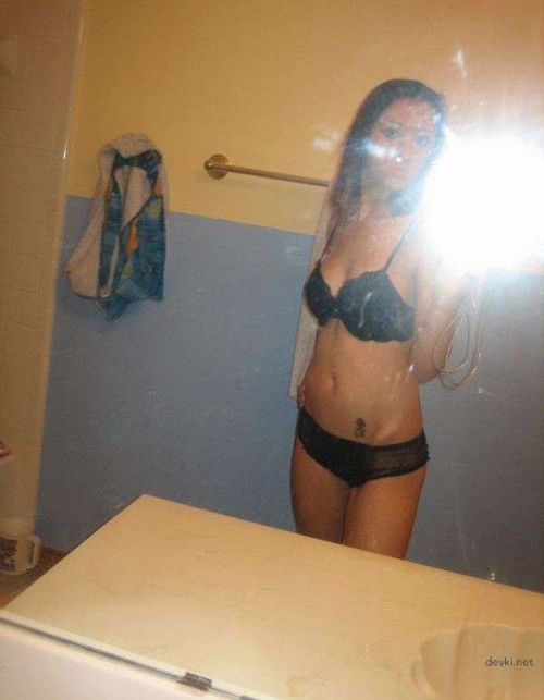 Seductive naked girl with amazing booty flaunting her curves