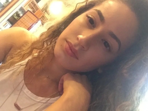 Curly-haired selfie girl flaunts her breasts in explicit photo
