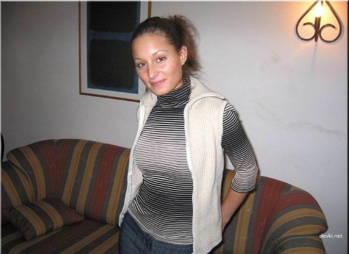 Slender Woman on Couch: Sensual Pose and Seductive Body